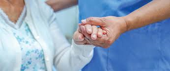 Nursing Assistant student holding patients hand