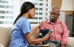 Nursing Assistant student taking elderly patient blood pressure
